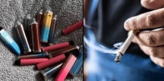 Osoba trzymająca e-papierosa podczas palenia