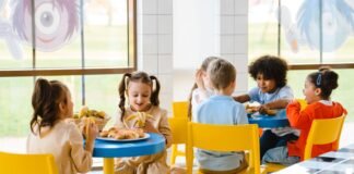 Dieta planetarna nie w smak uczniom? Rodzice z Otwocka powiedzieli, co dzieci myślą o nowych obiadach Dzieci jedzące wspólnie posiłek na szkolnej stołówce